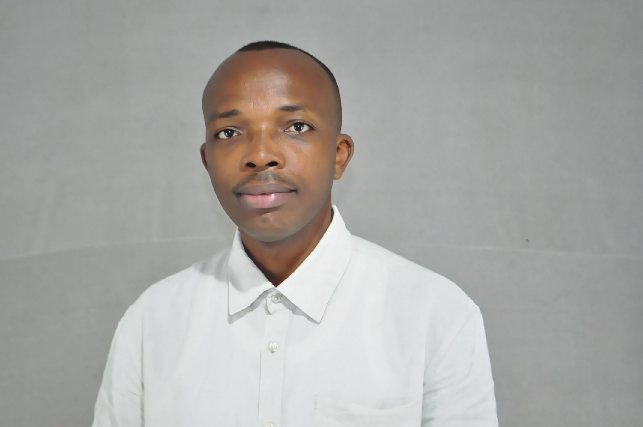man posing in front of a gray screen