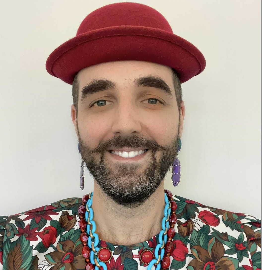 Person wearing a red hat, posing for a headshot.