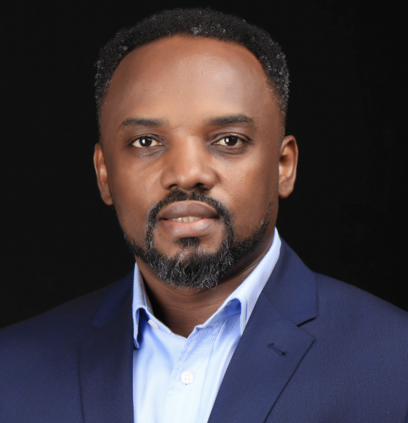 Black man in a blue jacket posing for a headshot