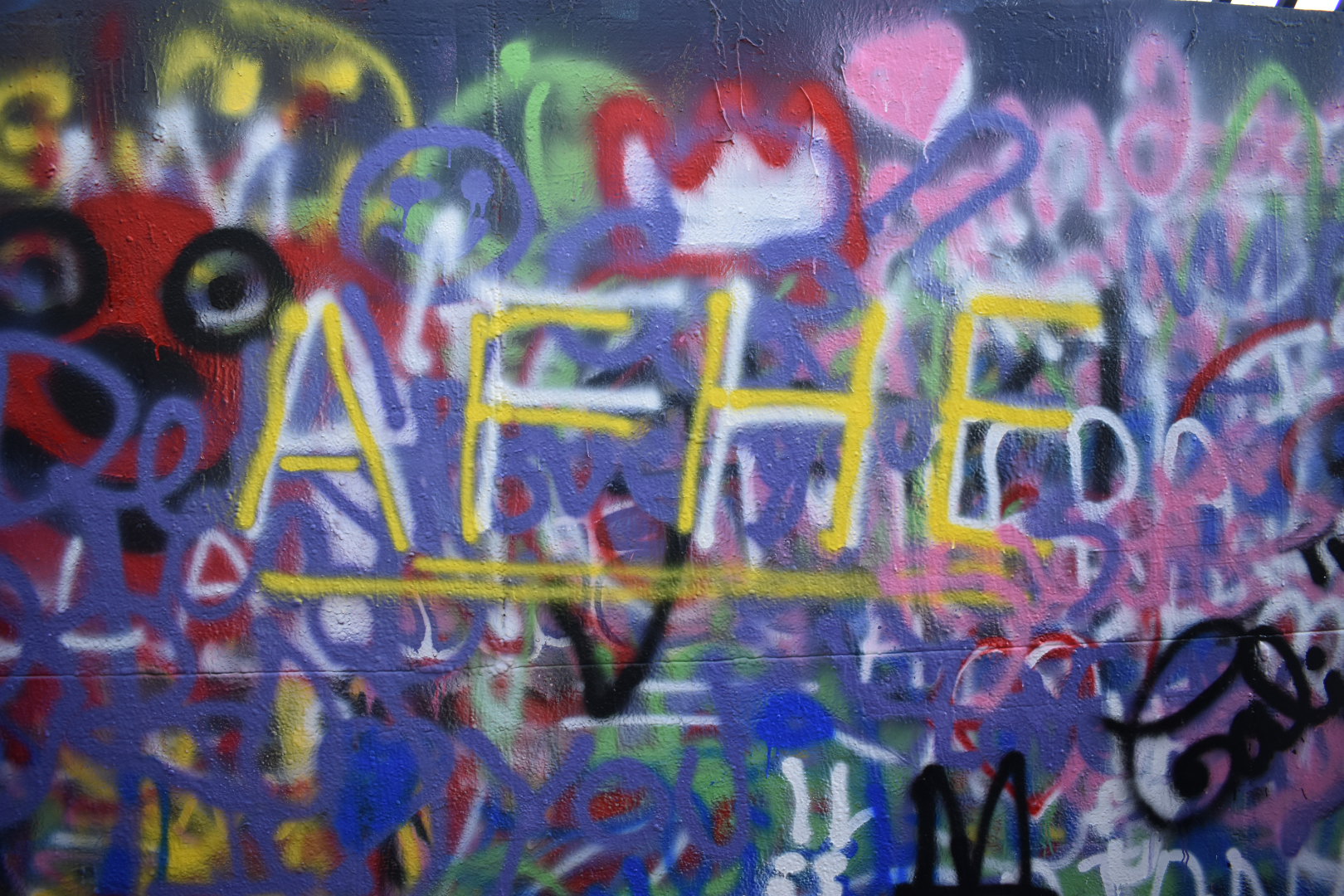 Painted letters A, F, H and E on a graffiti wall