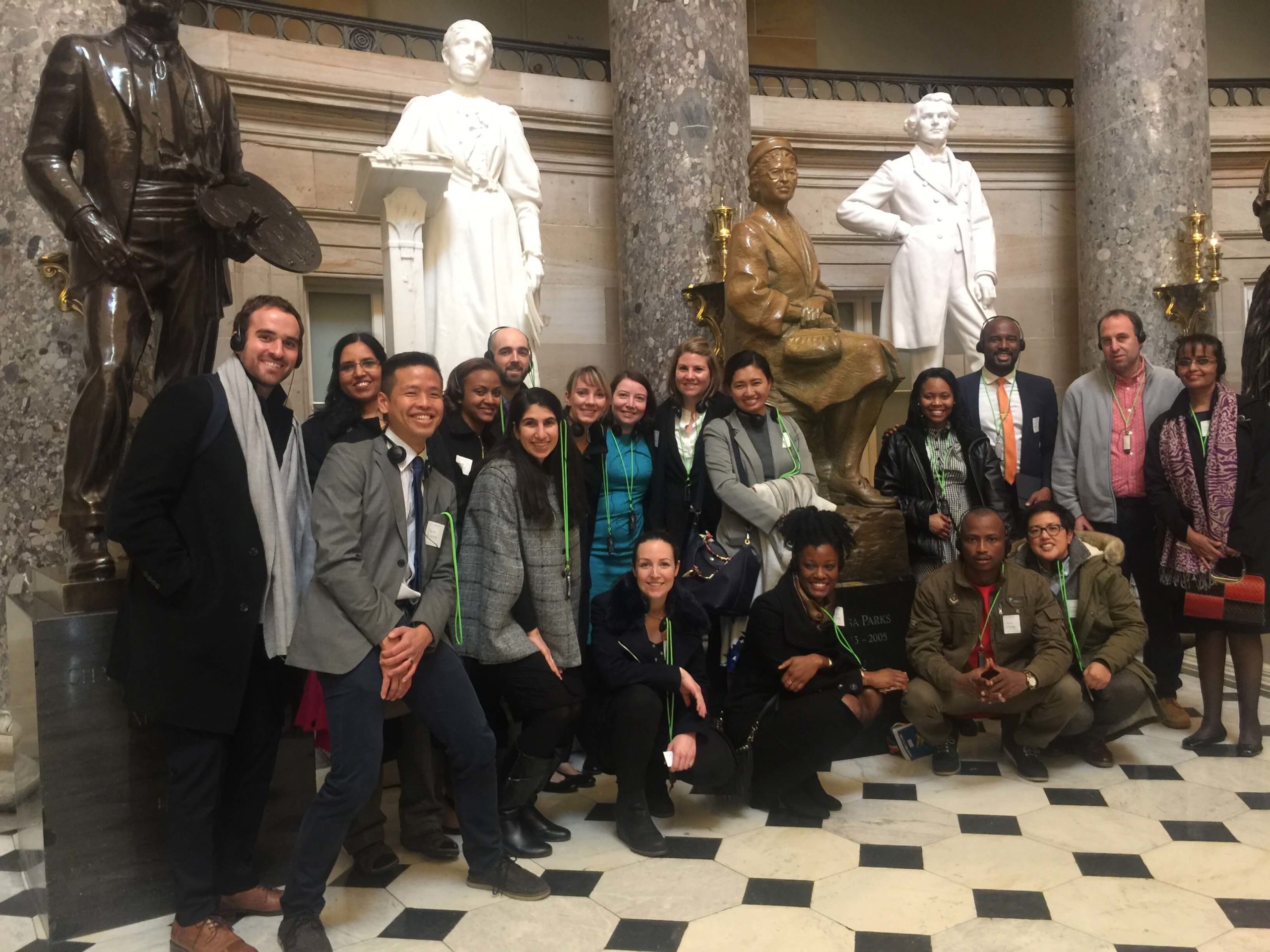 group of people in front of statues