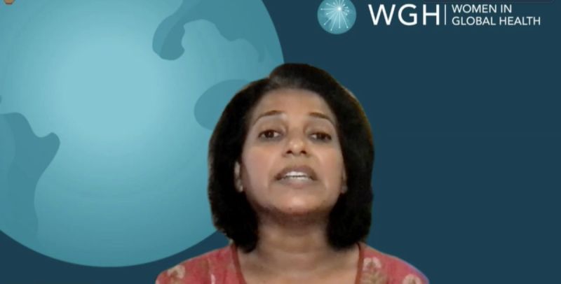 woman speaking in front of globe graphic