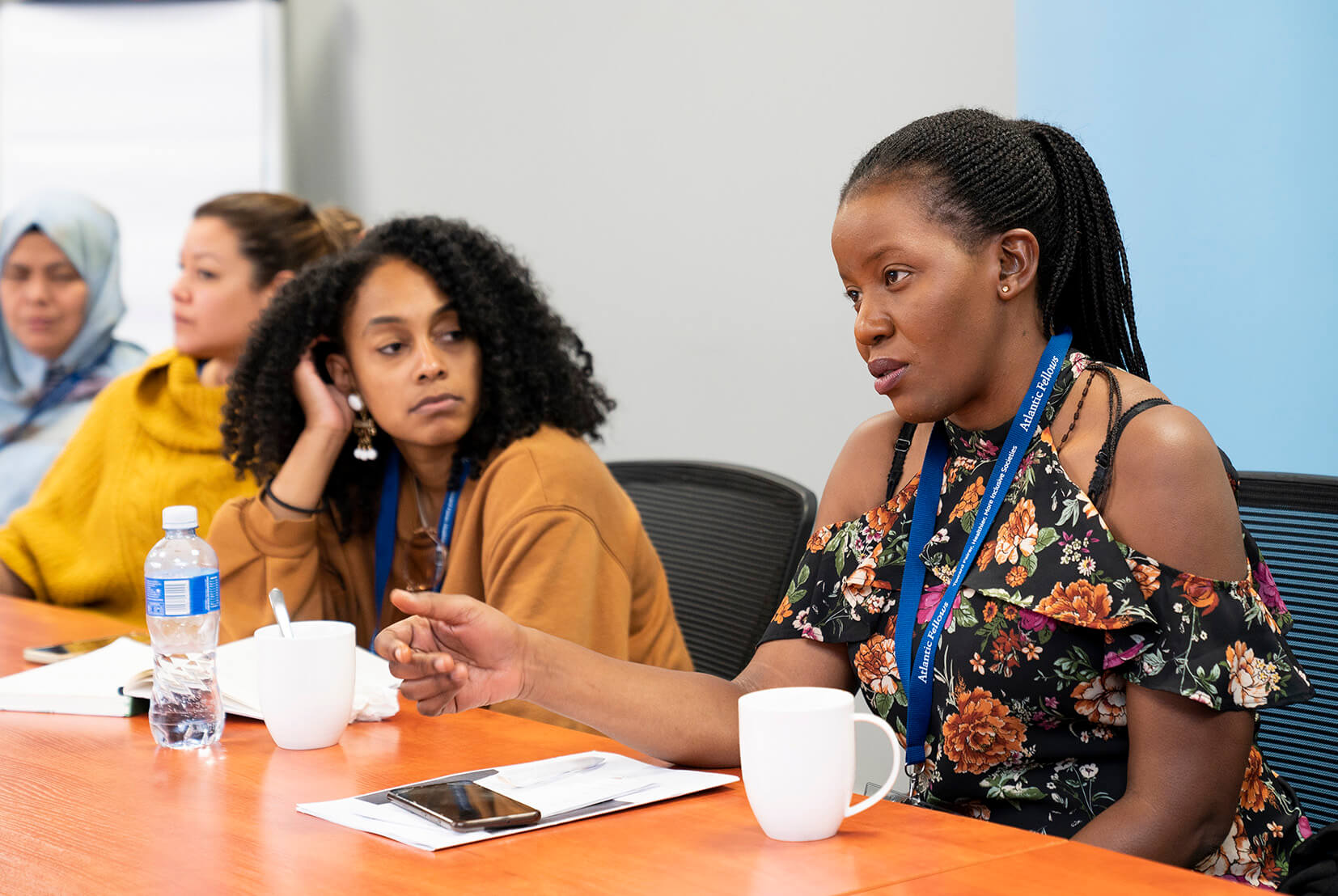 women sitting at a table in discussion