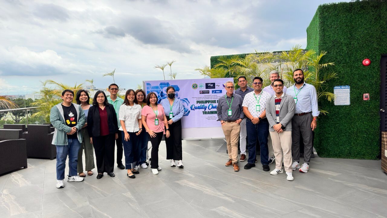 group of people standing in front of a sign