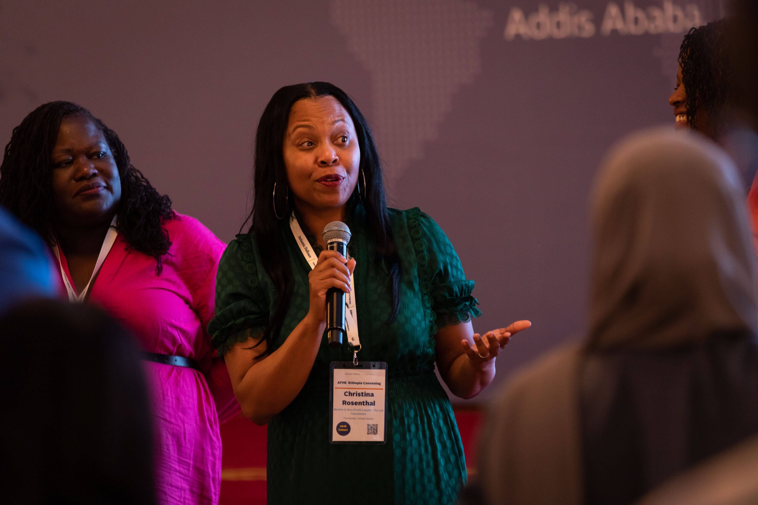 Black woman speaking into a microphone.