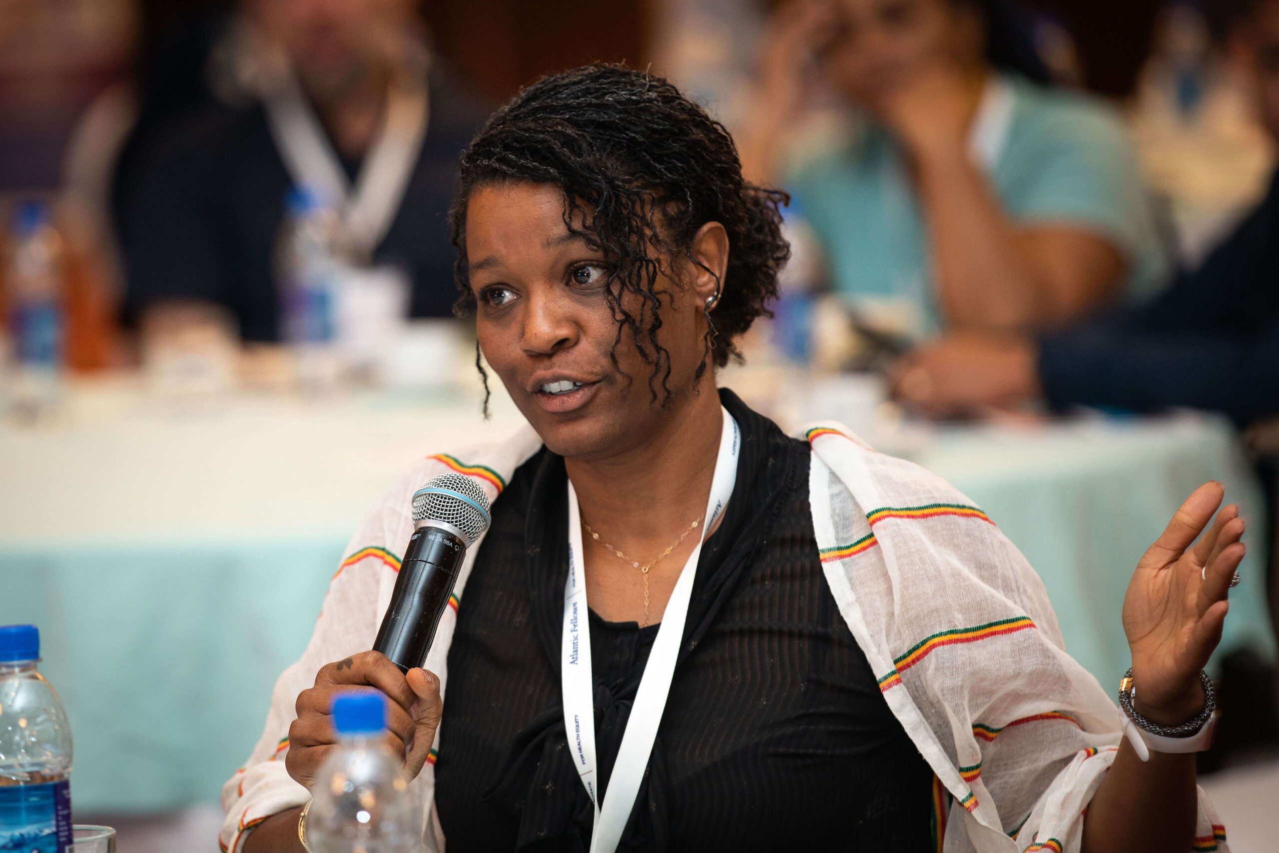 Black woman speaking into a microphone.