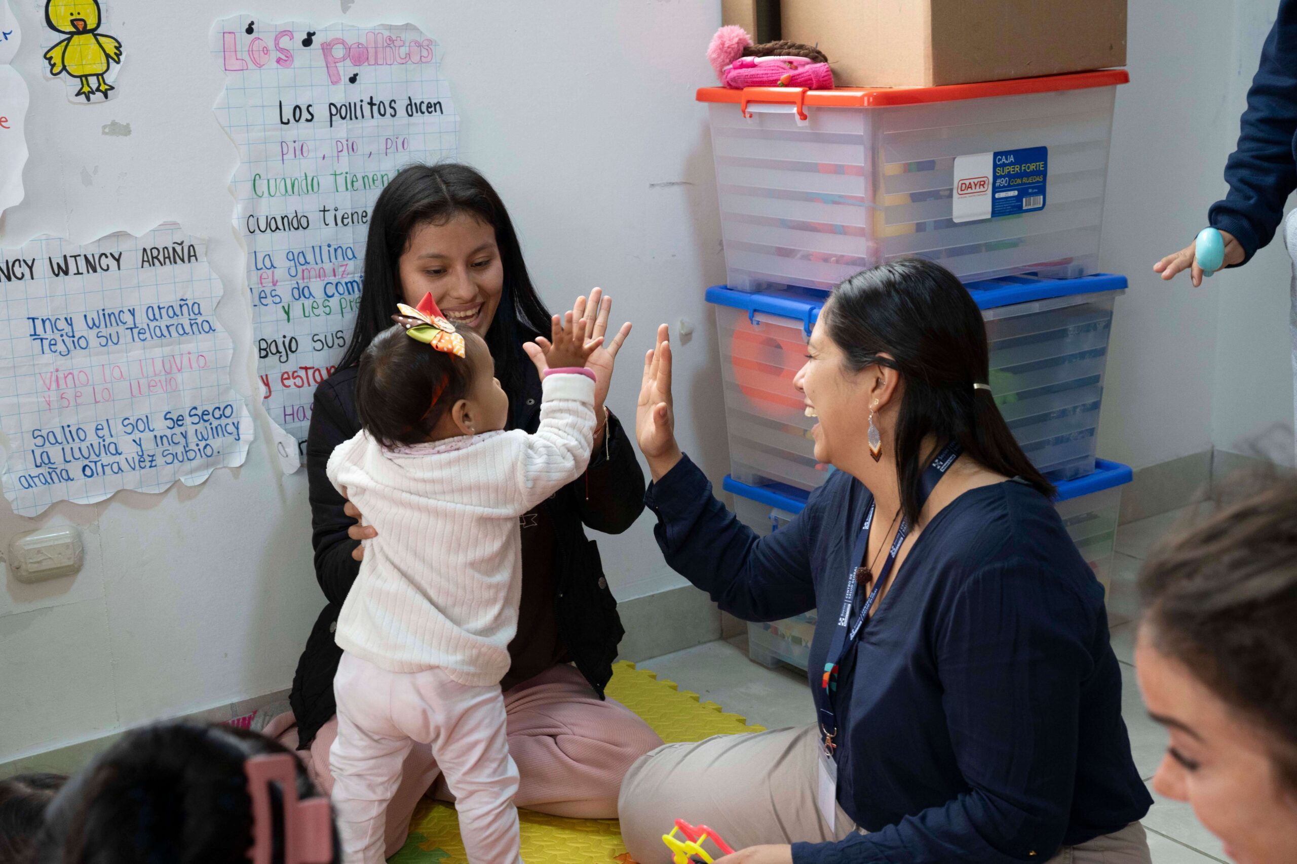 Woman high fiving a small child.