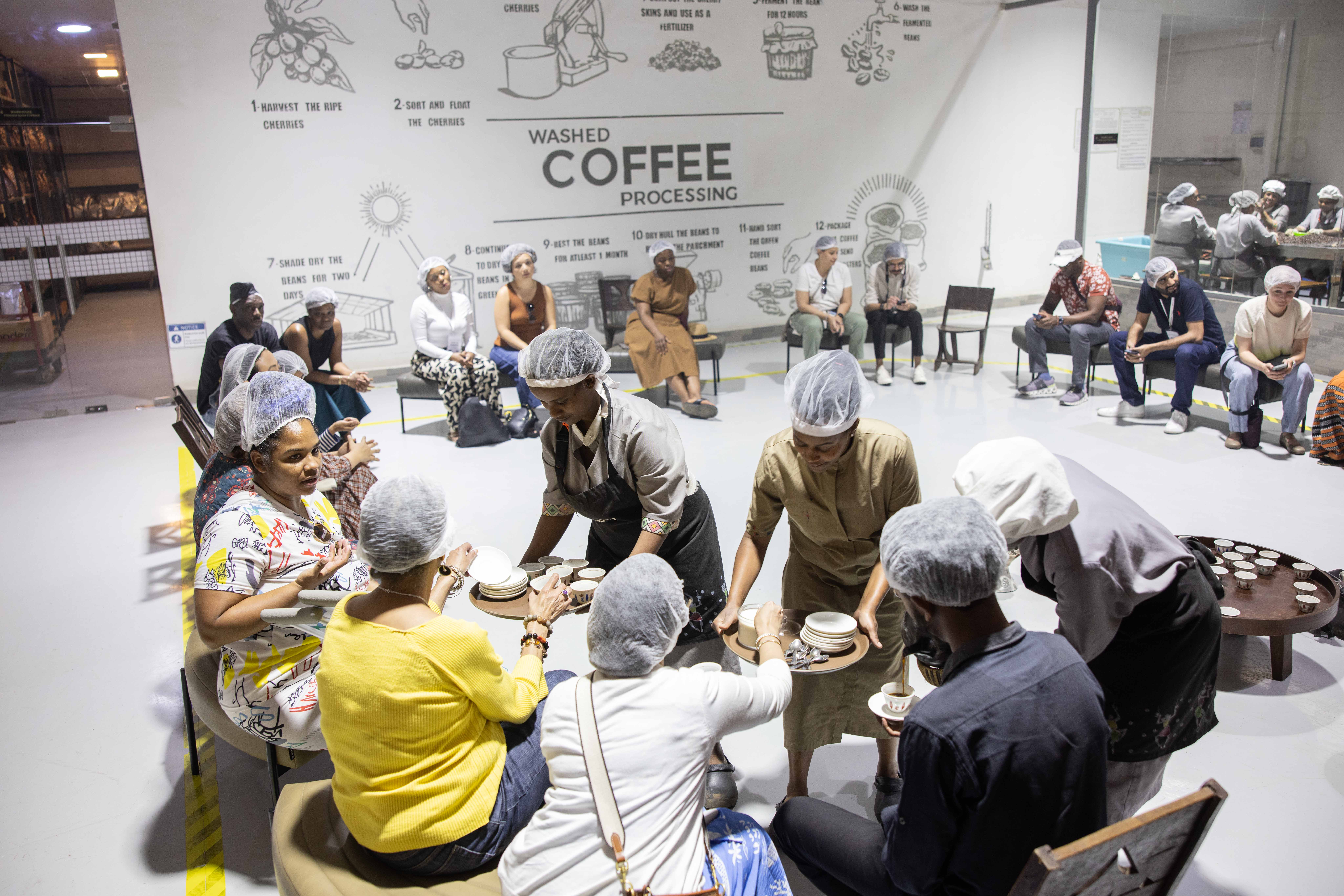 group of people in hair nets at a coffee roasting plant