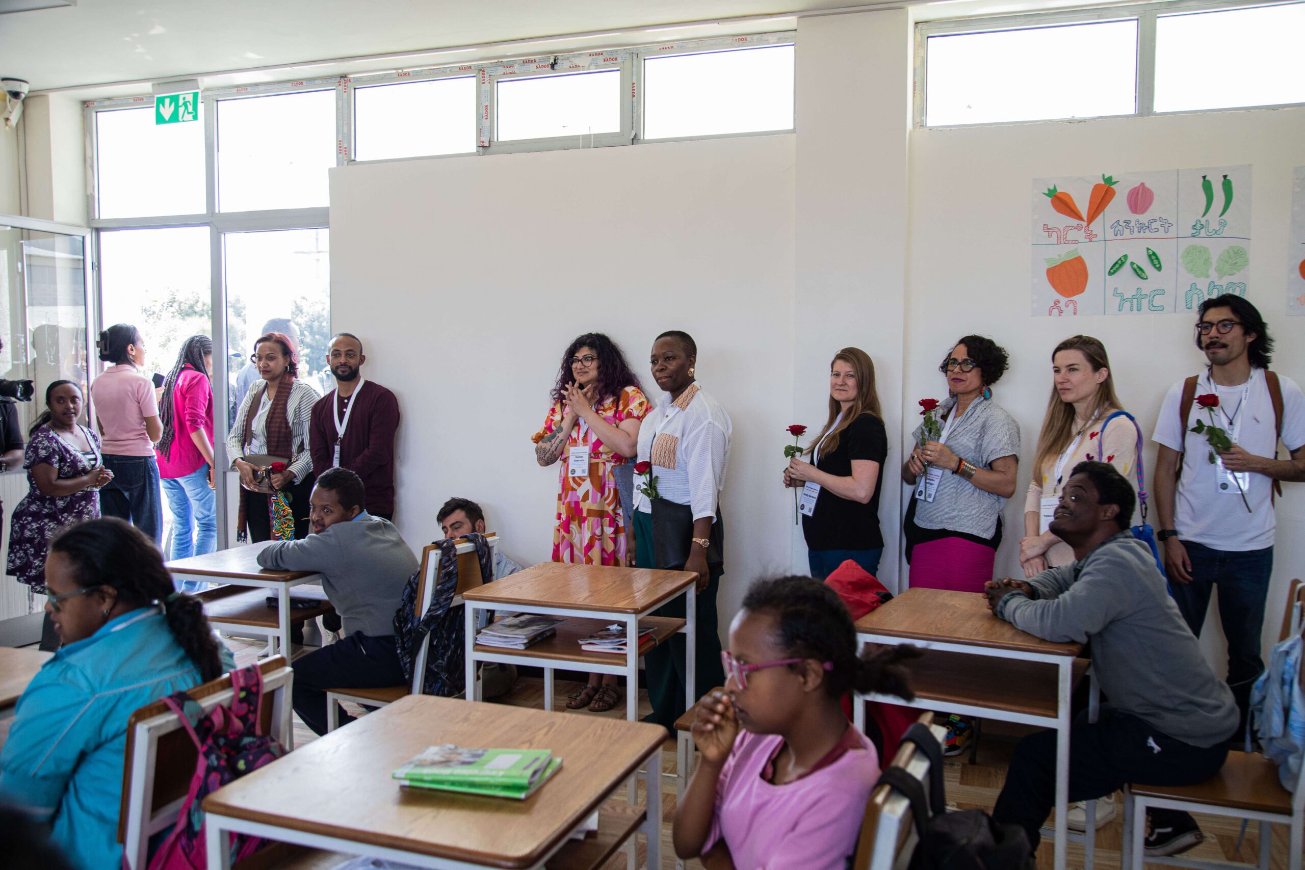 group of adults and children in a classroom