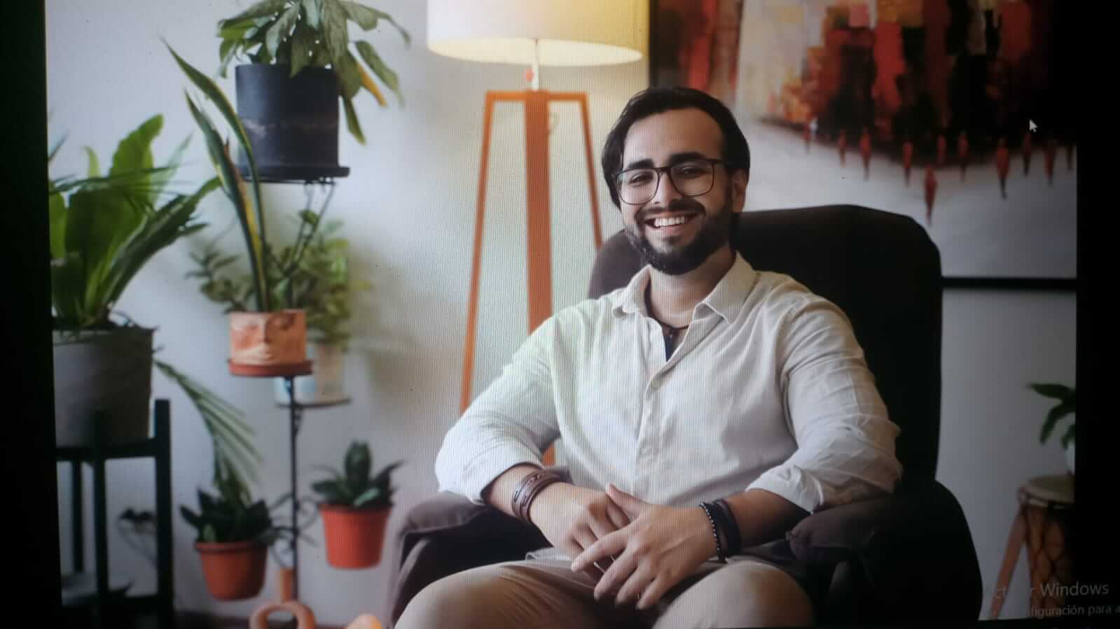 Man sitting in a chair posing for a picture.