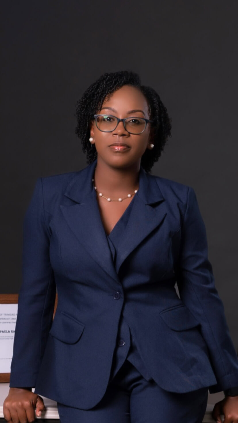Woman in a dark blue suit against a dark gray background.