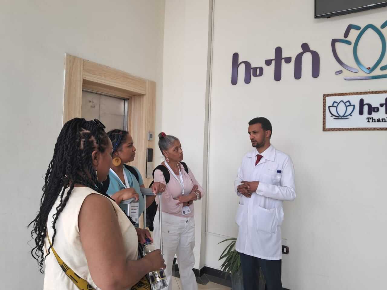 three women speaking to a doctor