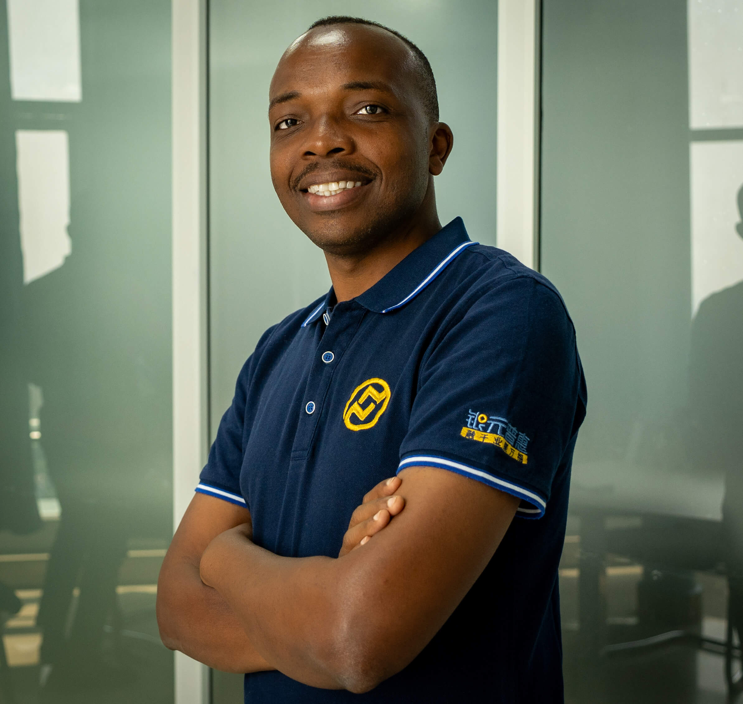 Black man crossing his arms and posing for a picture