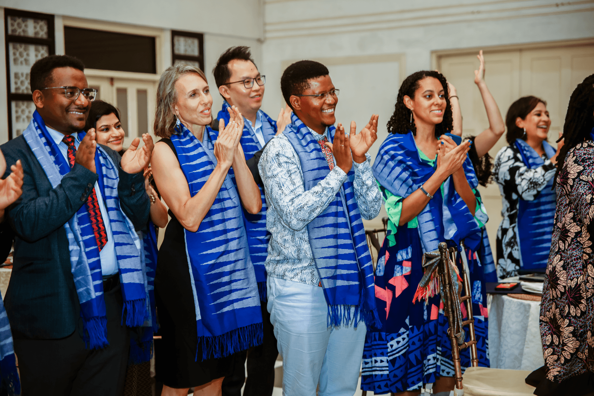 Group of diverse people in scarves clapping