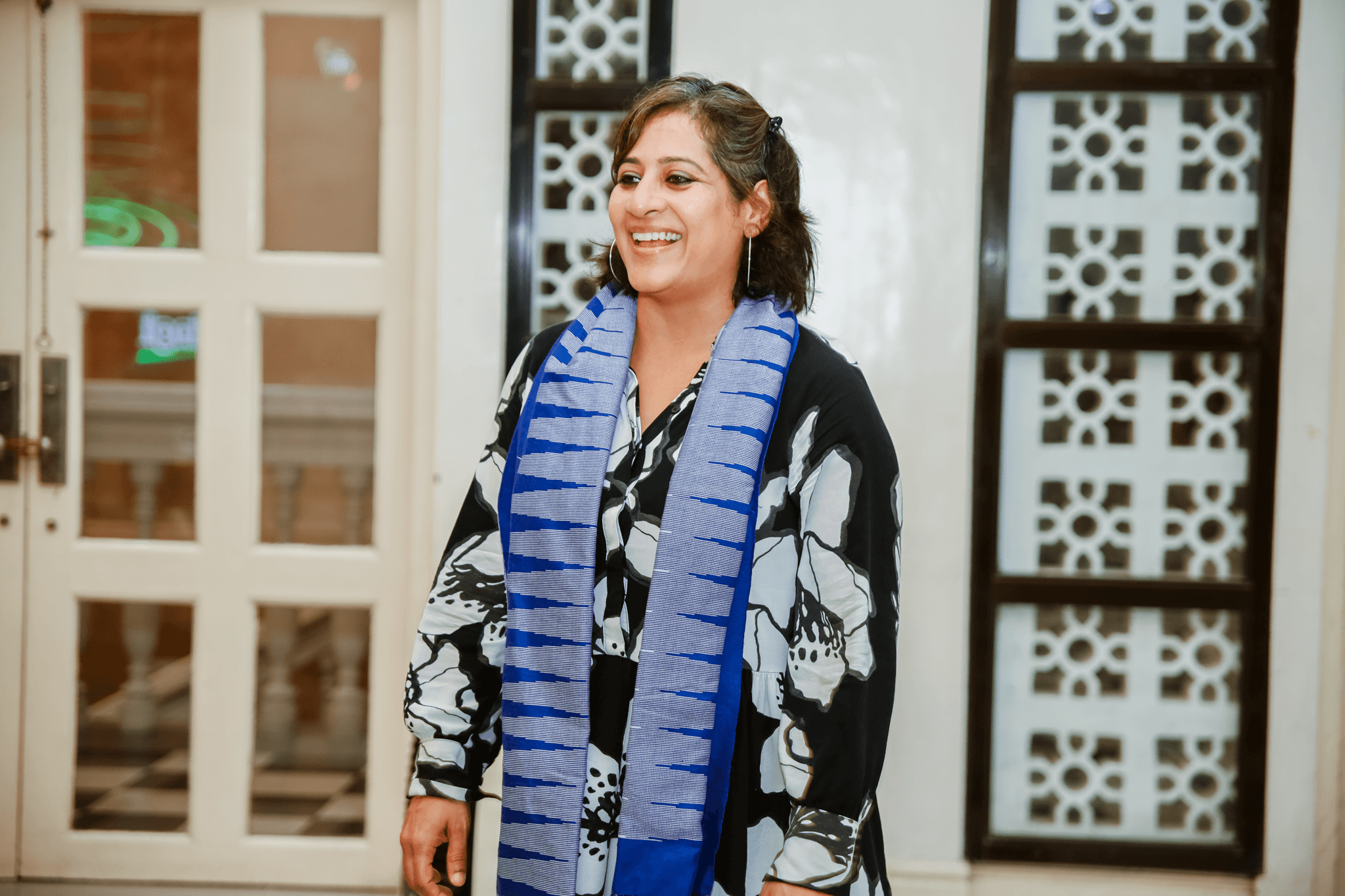 woman in a black dress and blue scarf