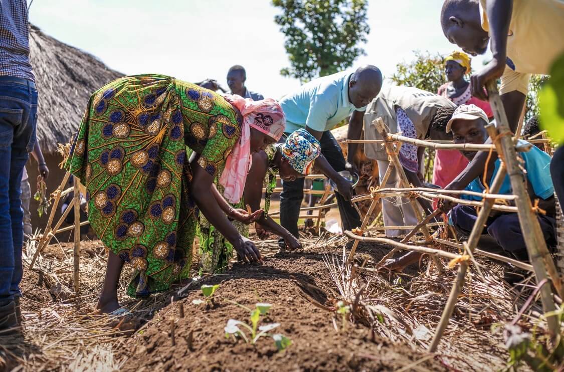 A group of black people outside farming.