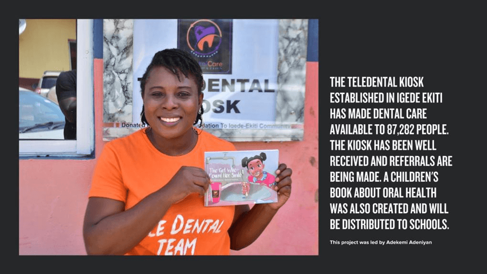 A smiling woman in an orange shirt holds up a children's book titled "The Girl Who Found Her Smile" next to text about a teledental kiosk project.